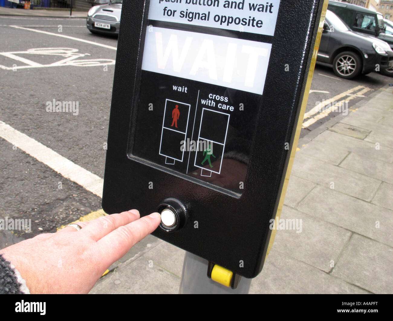 Pressing the button at a pelican pedestrian crossing, UK. Stock Photo