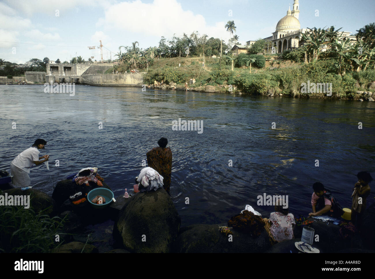 Women wash clothes in the waters of the River Argus which flows in the