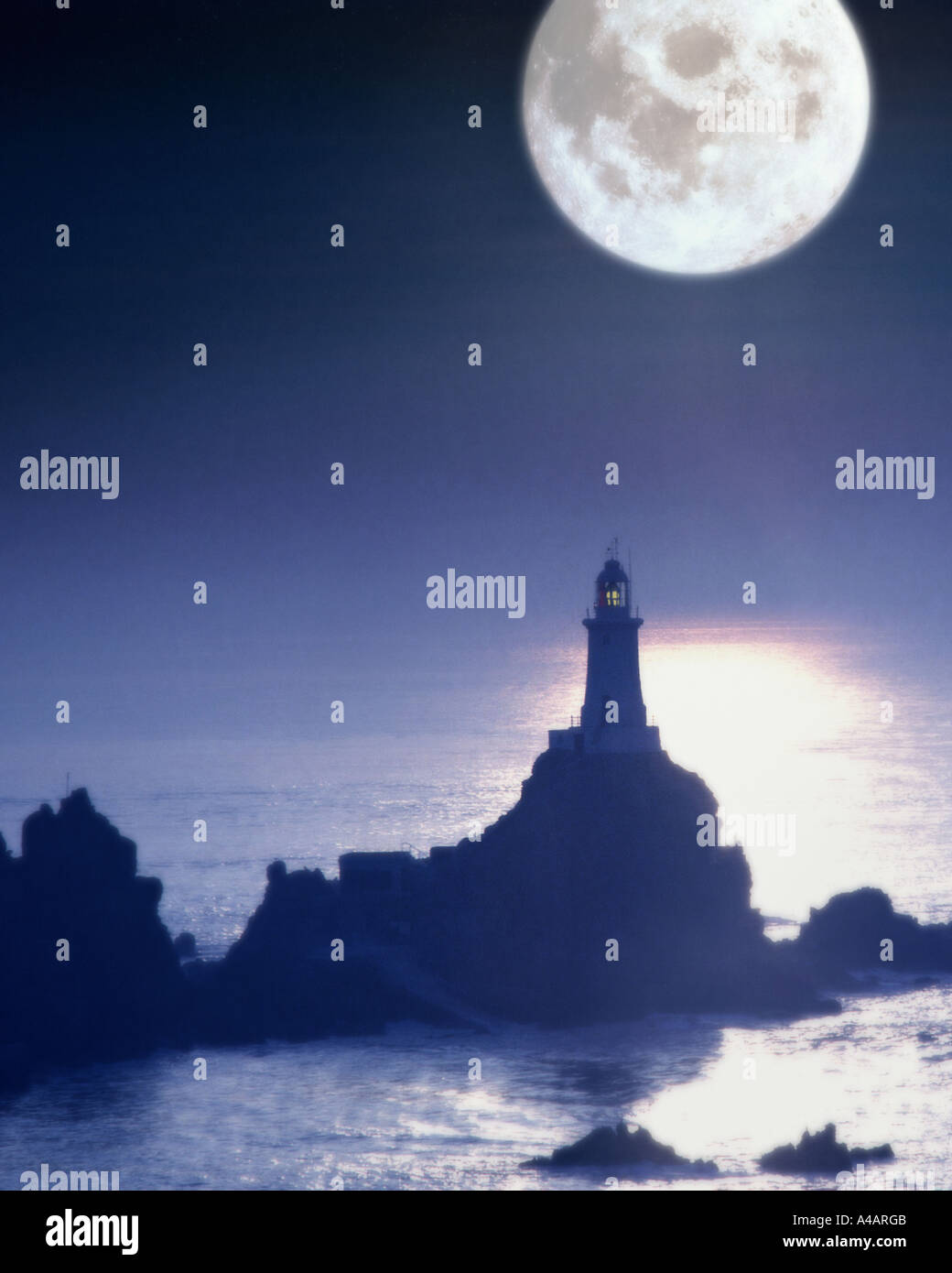 GB - JERSEY: Moon over La Corbiere Lighthouse Stock Photo