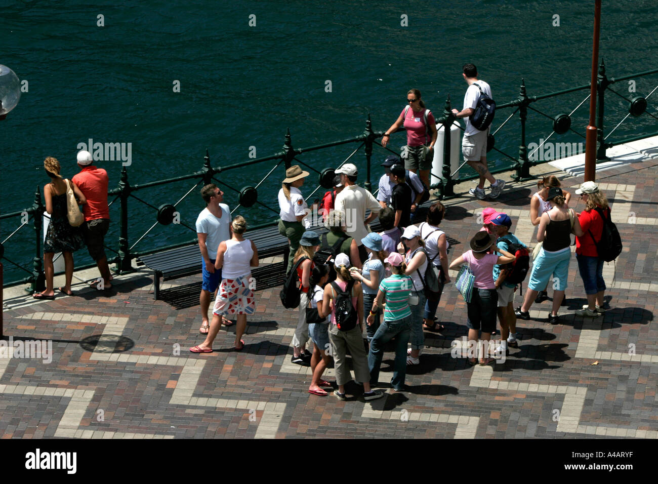 A group of tourists with National Parks ranger at Circular quay in Sydney Australia Stock Photo