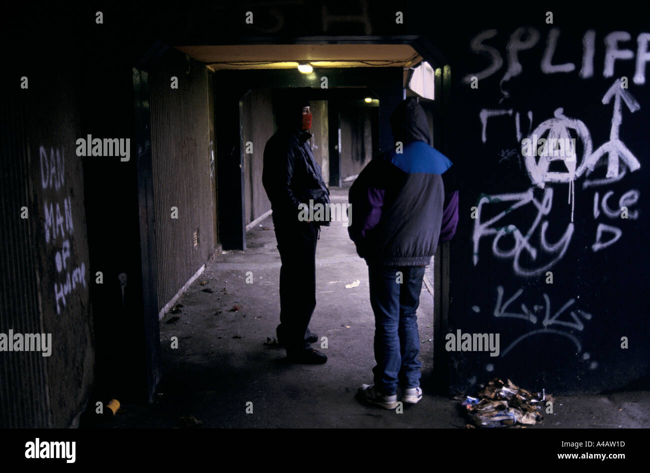 Drug dealers talking on the street in a run down part of Moss Side, Manchester, England Stock Photo