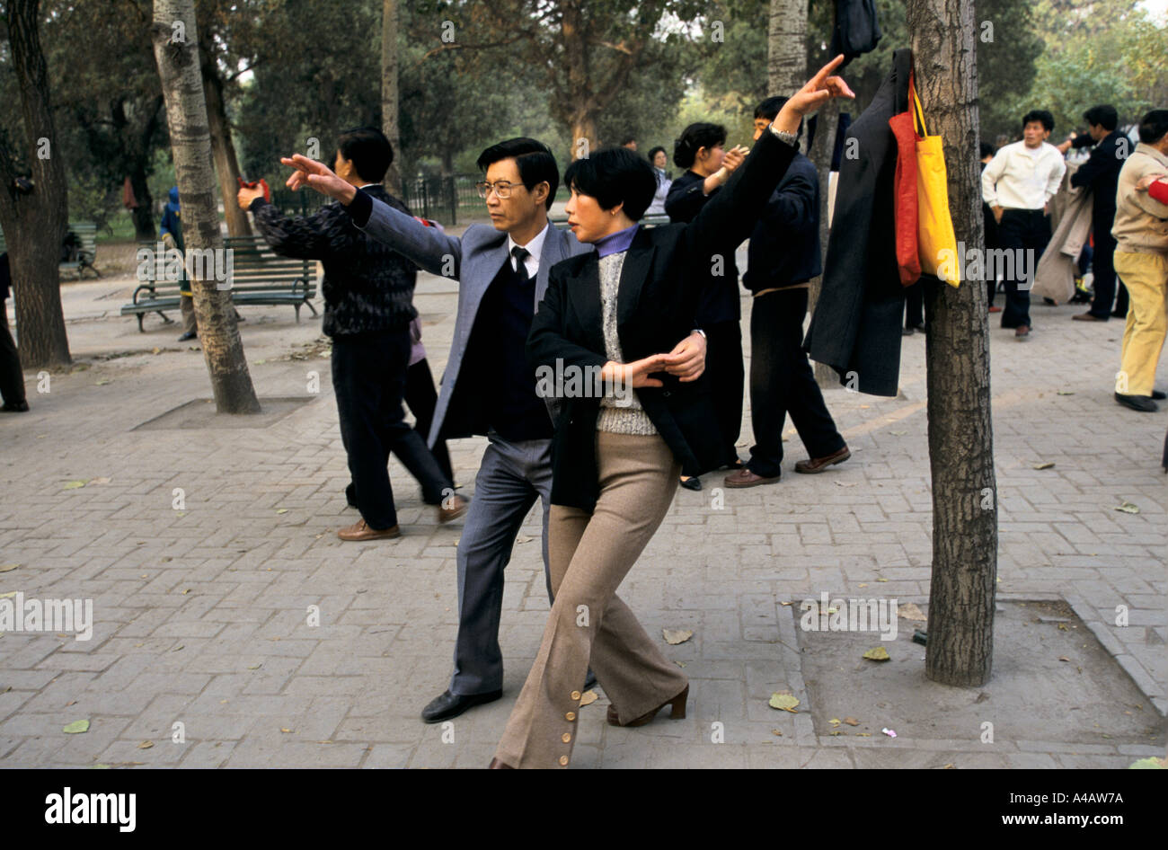 Beijing, China 1997:  a couple takes part in a ballroom dancing class under the trees in Ritan Park before work. Stock Photo