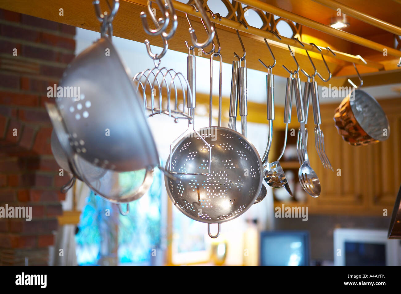 Cooking utensils hanging in a kitchen Stock Photo - Alamy