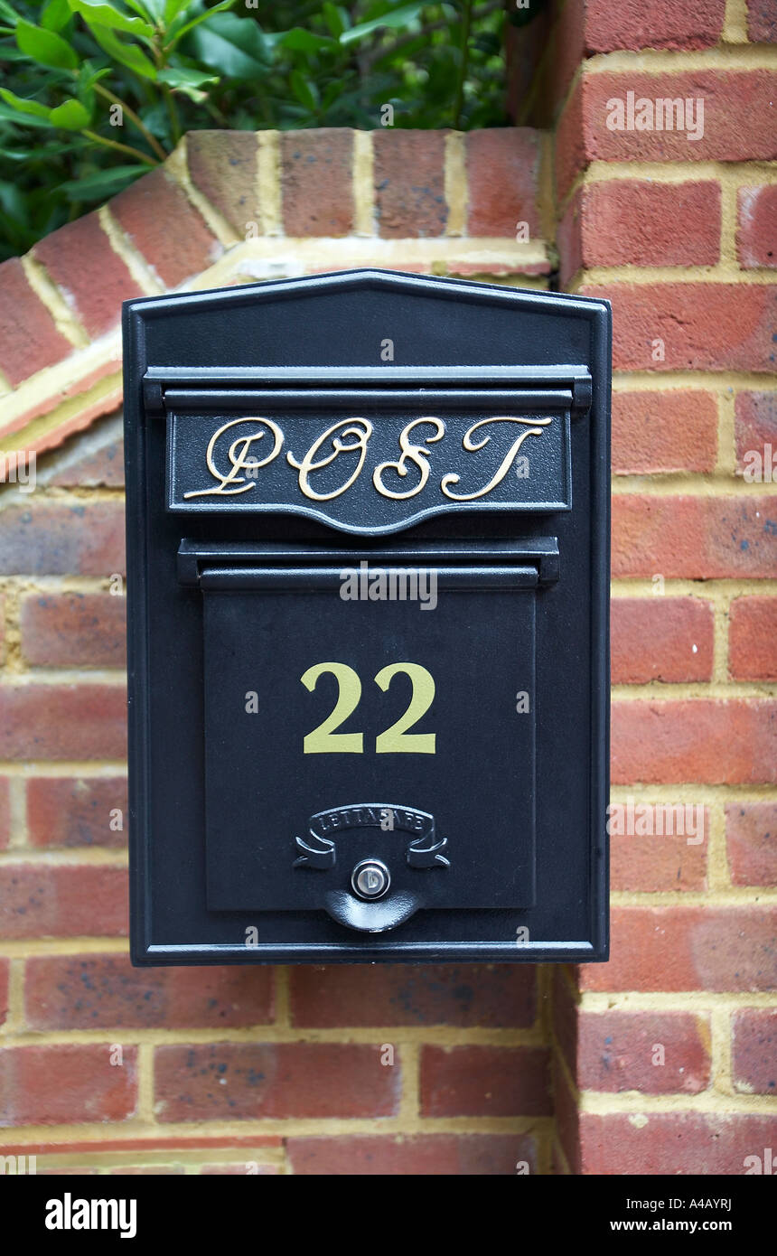 black letter box on red brick wall Stock Photo