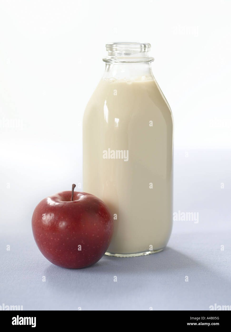 Bottle of Milk and Red Apple Stock Photo