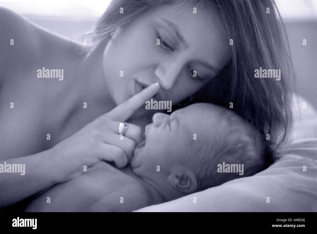 mother shushing her newborn baby who is screaming yelling crying