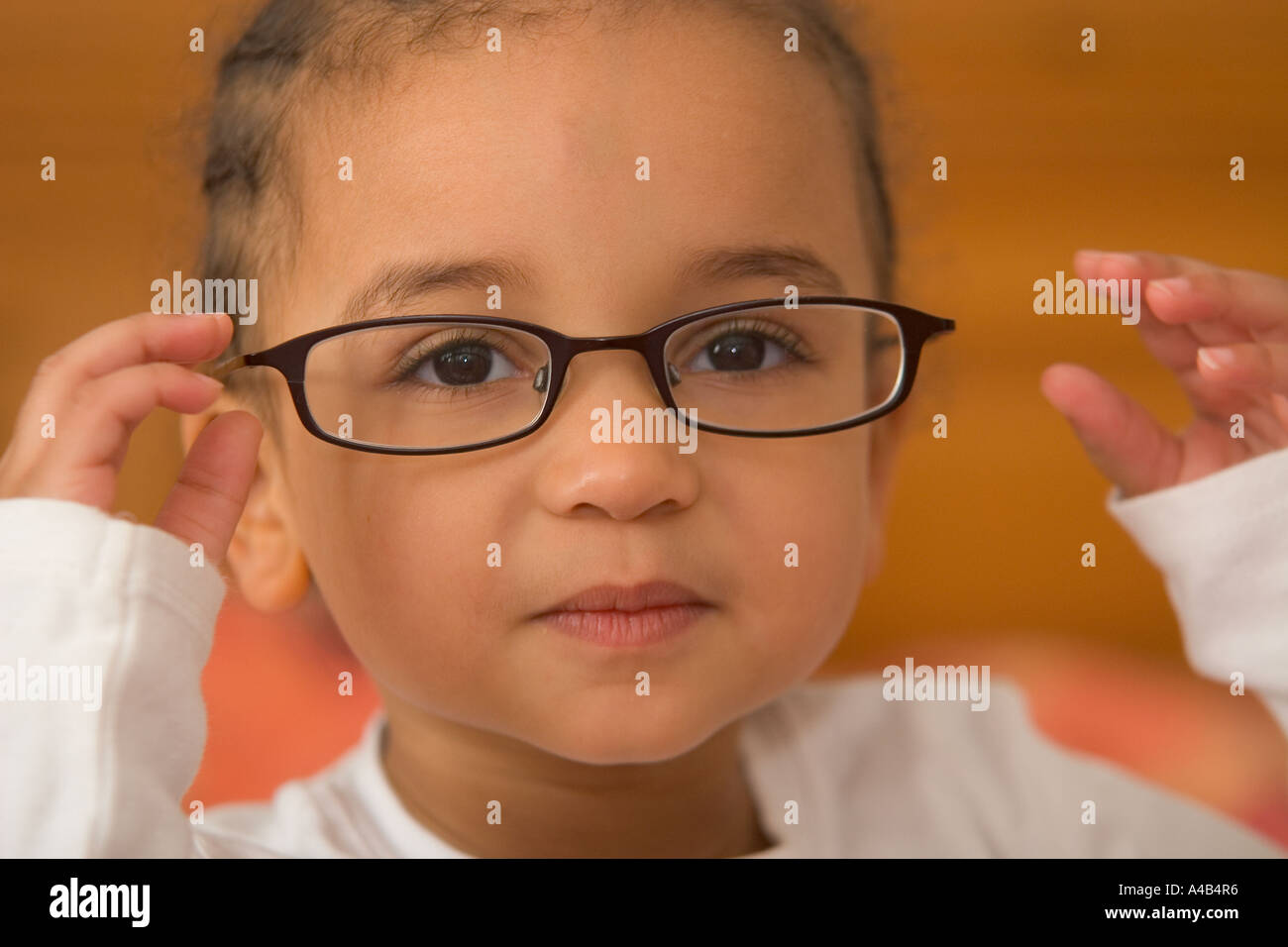 A beautiful young mixed race girl wearing oversized glasses Stock Photo