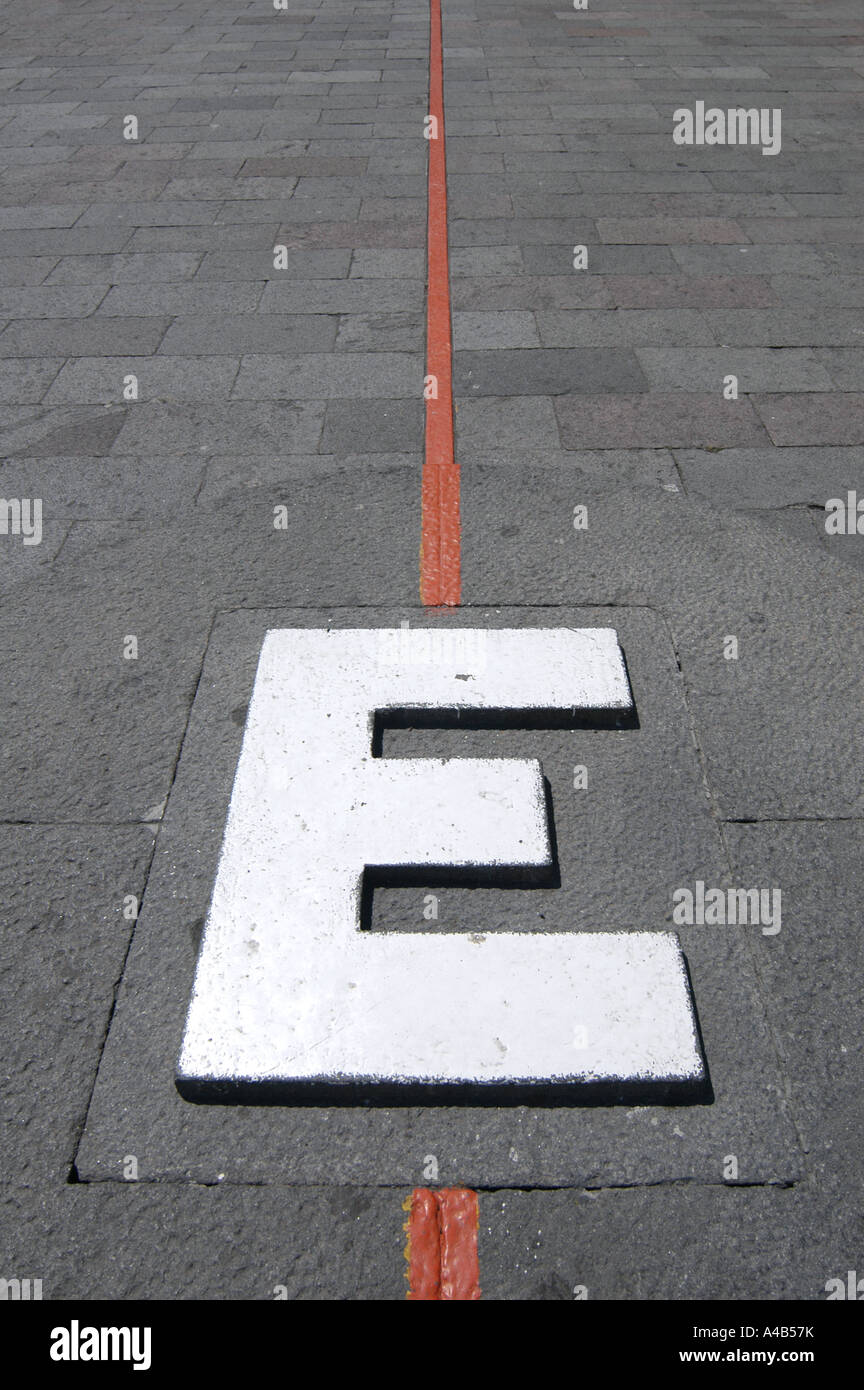 Symbolic Equator line and huge letter 'E' in foot of the Monument Mitad del Mundo (Middle of the World) near Quito, Ecuador Stock Photo
