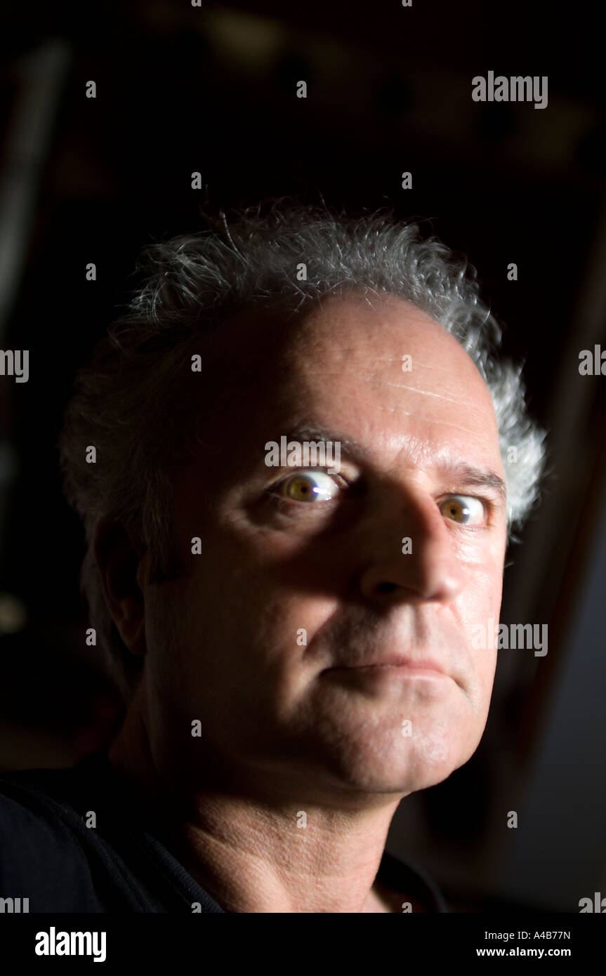 Dramatic portrait of middle aged man looking terrified Stock Photo