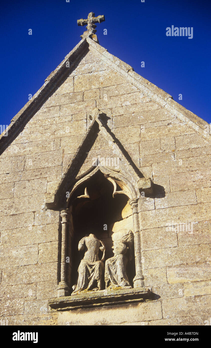 Niche above sandstone church porch in which female and male figures have lost their heads in 16th century Reformation Stock Photo
