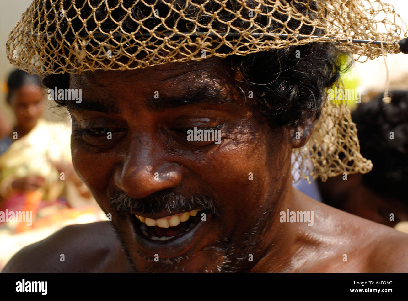 Stock image of Indian tribal fishermen fishers repairing their fishing nets near Chennai Tamil Nadu India Stock Photo