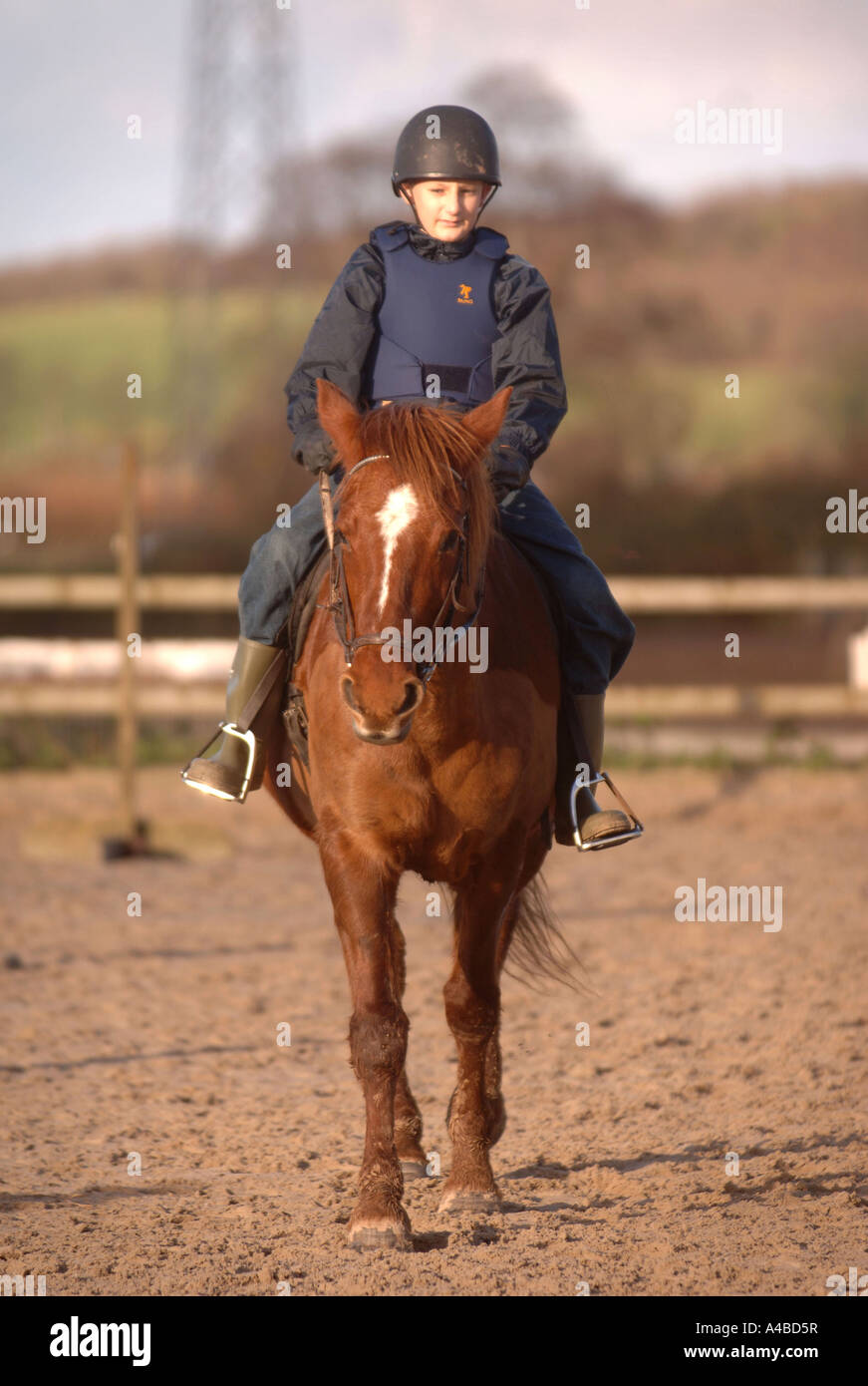A SCHOOL CHILD LEARNING TO RIDE AT A RIDING SCHOOL SOMERSET UK Stock Photo
