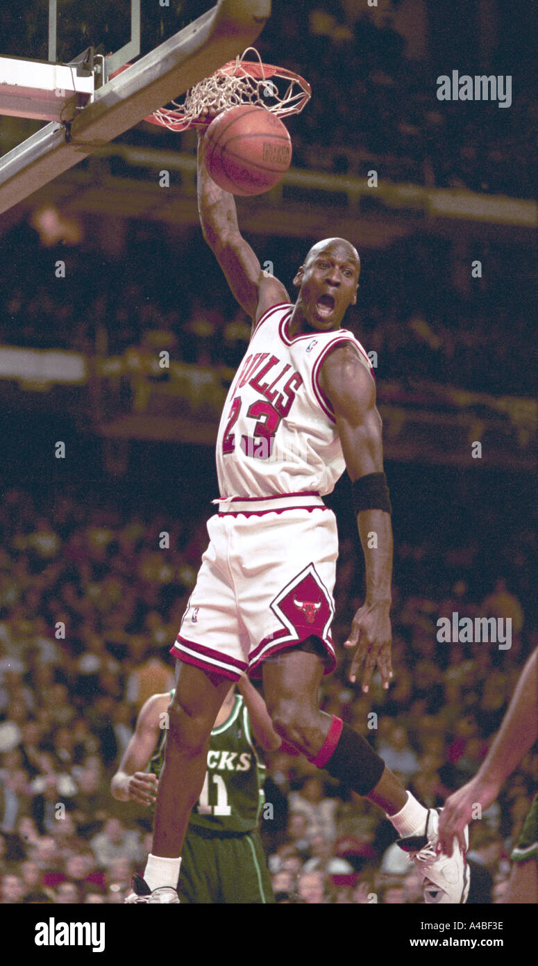 Chicago Bulls and NBA superstar Michael Jordan stuffs a basketball during game action in 1991 Stock Photo