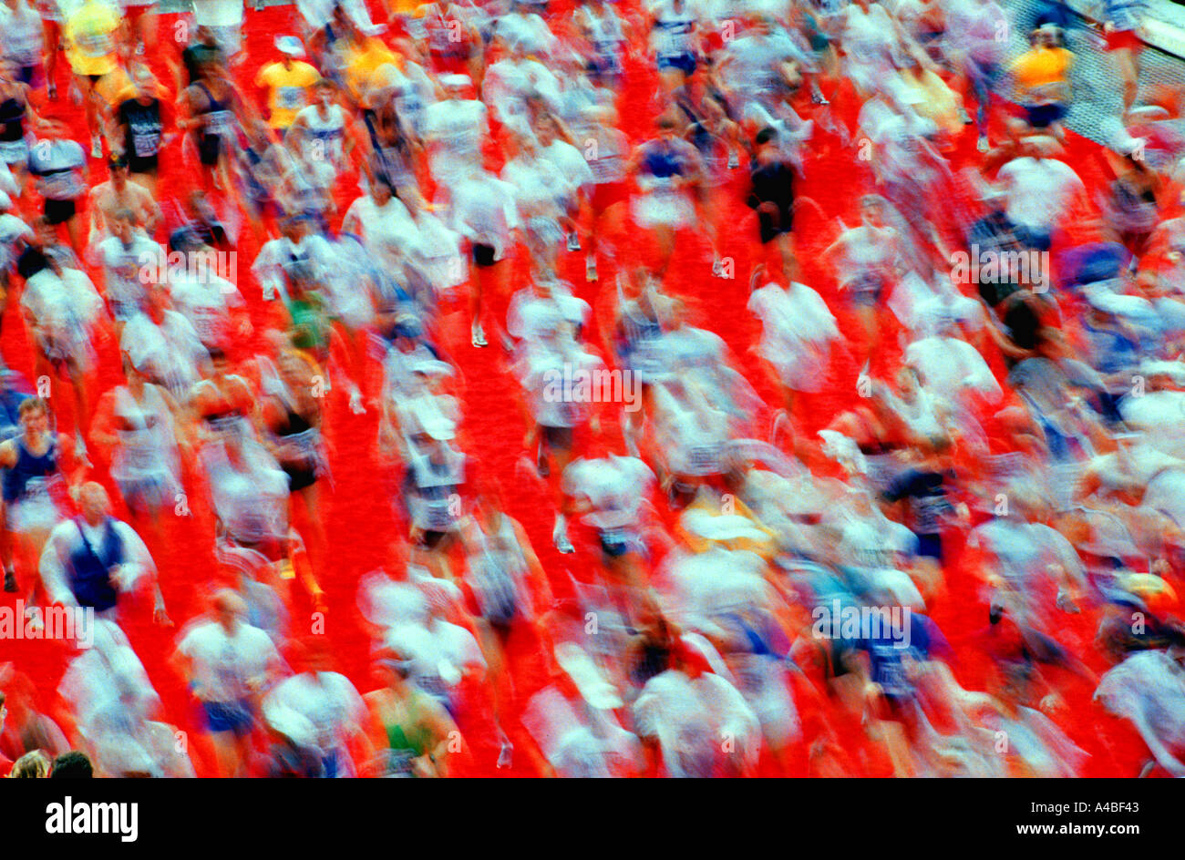 Marathon athletes run on a red carpet Stock Photo