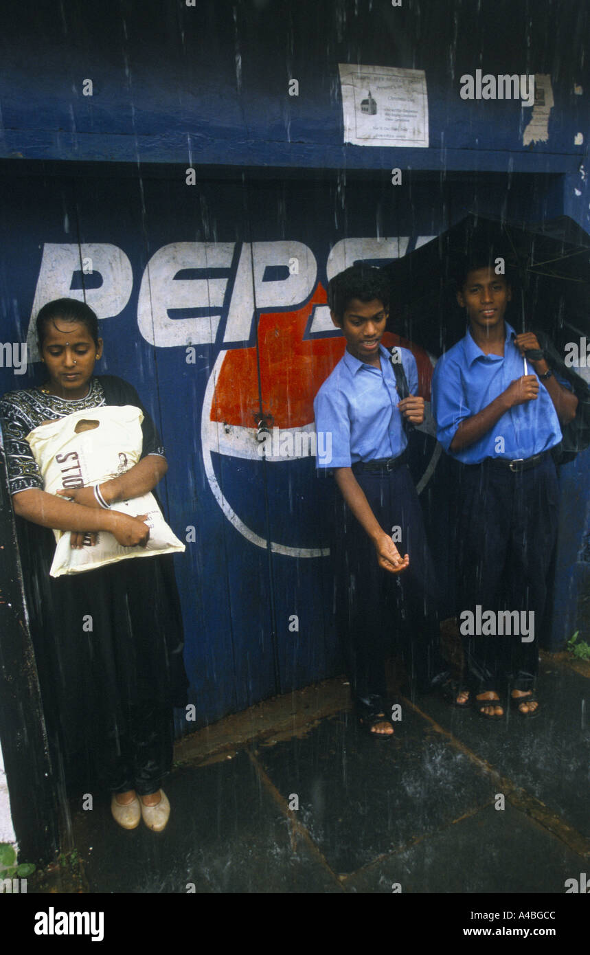 Monsoon Story, India', Goa. School Children Going Home In Heavy Rain In The Market Town Of Mapusa, 1999 Stock Photo