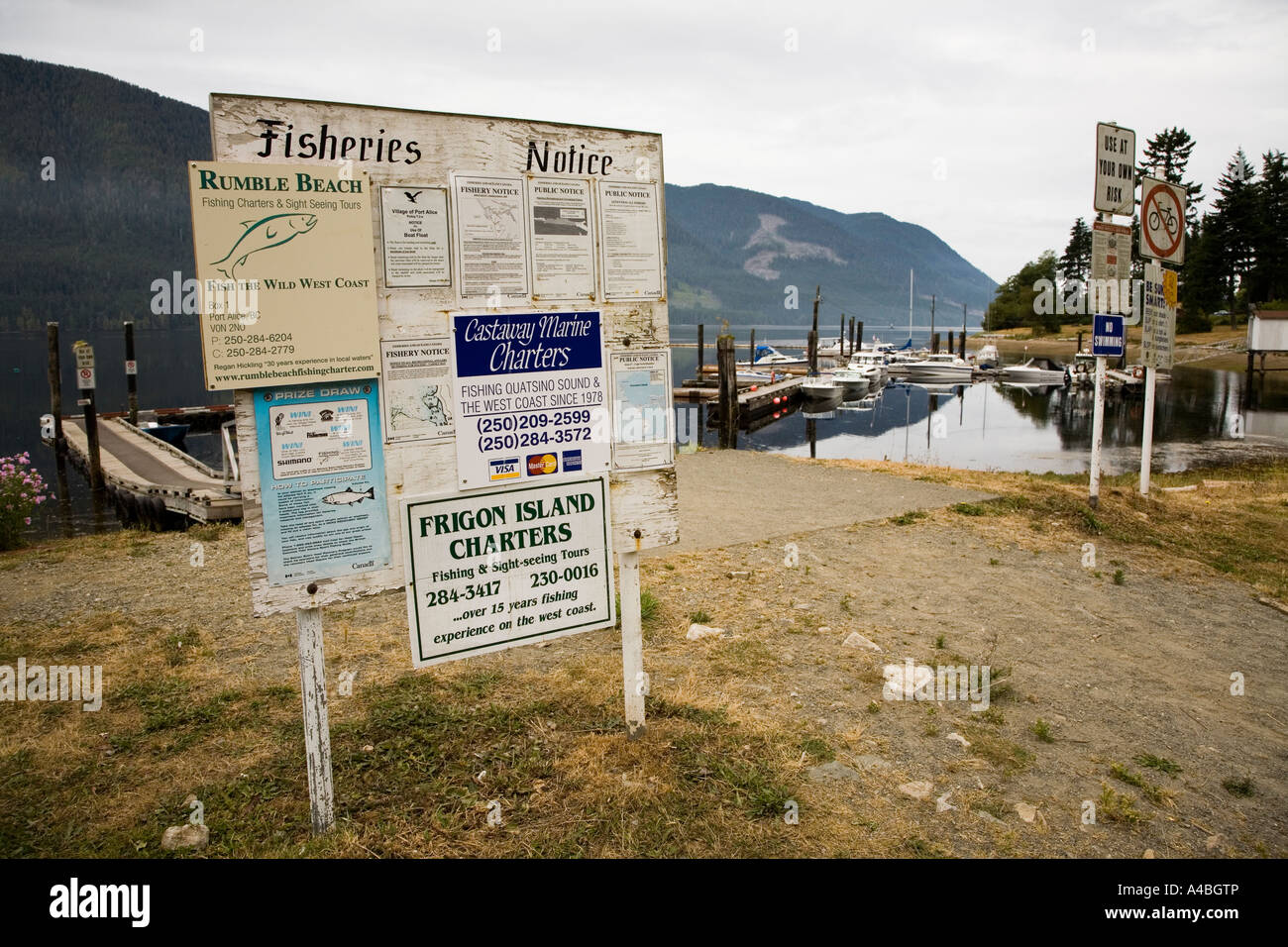 Run down signs and notices at harbour for Port Alice on the west coast of Vancouver island Canada Stock Photo