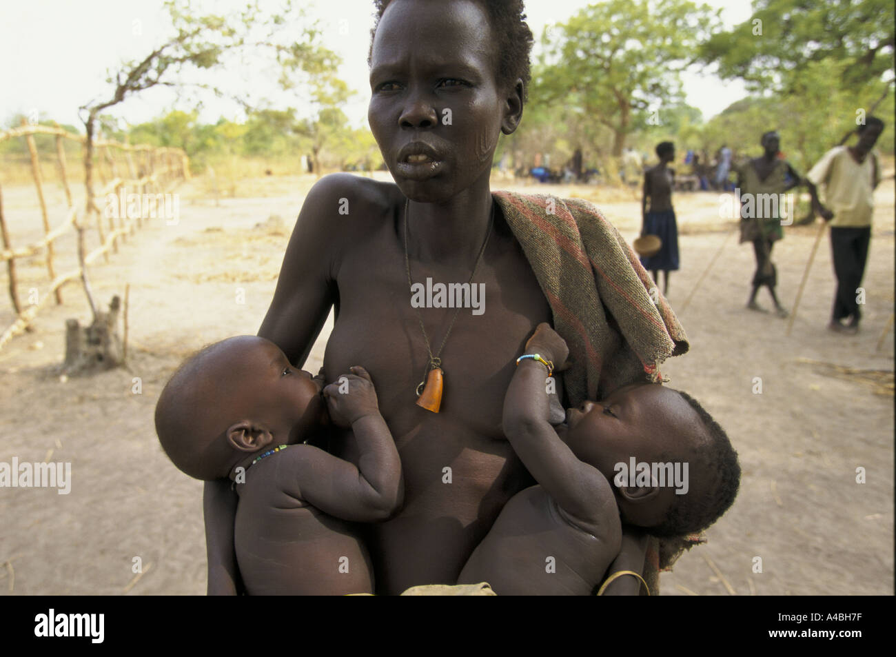 southern sudan ageip village mother and her twins Stock Photo
