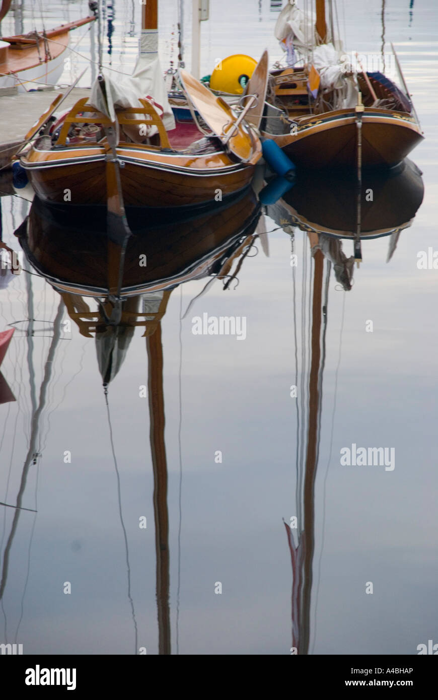 A pair of Dutch sail boats reflected in the water Stock Photo - Alamy