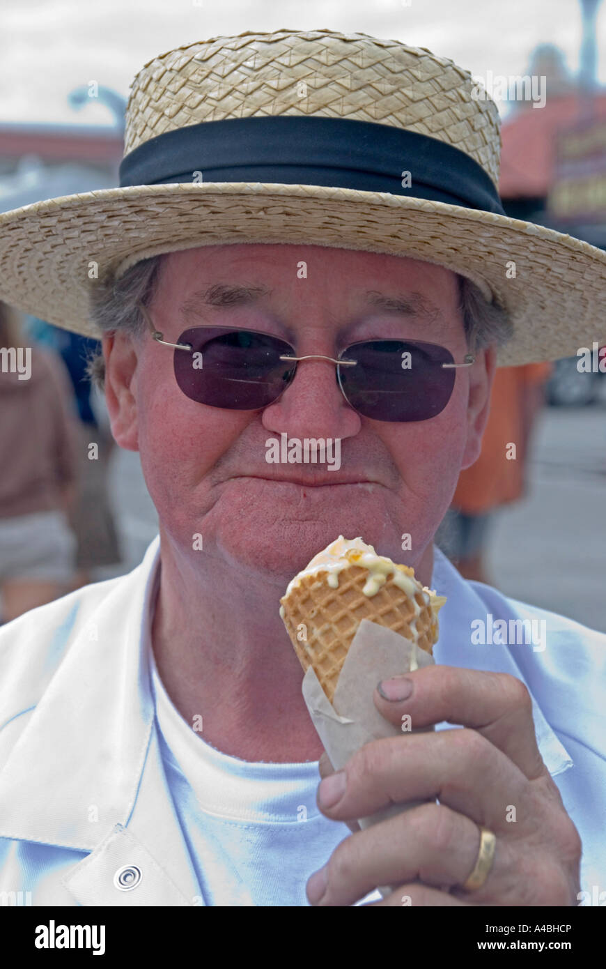 A Man In A Straw Boater Hay With An Ice Cream Stock Photo Alamy