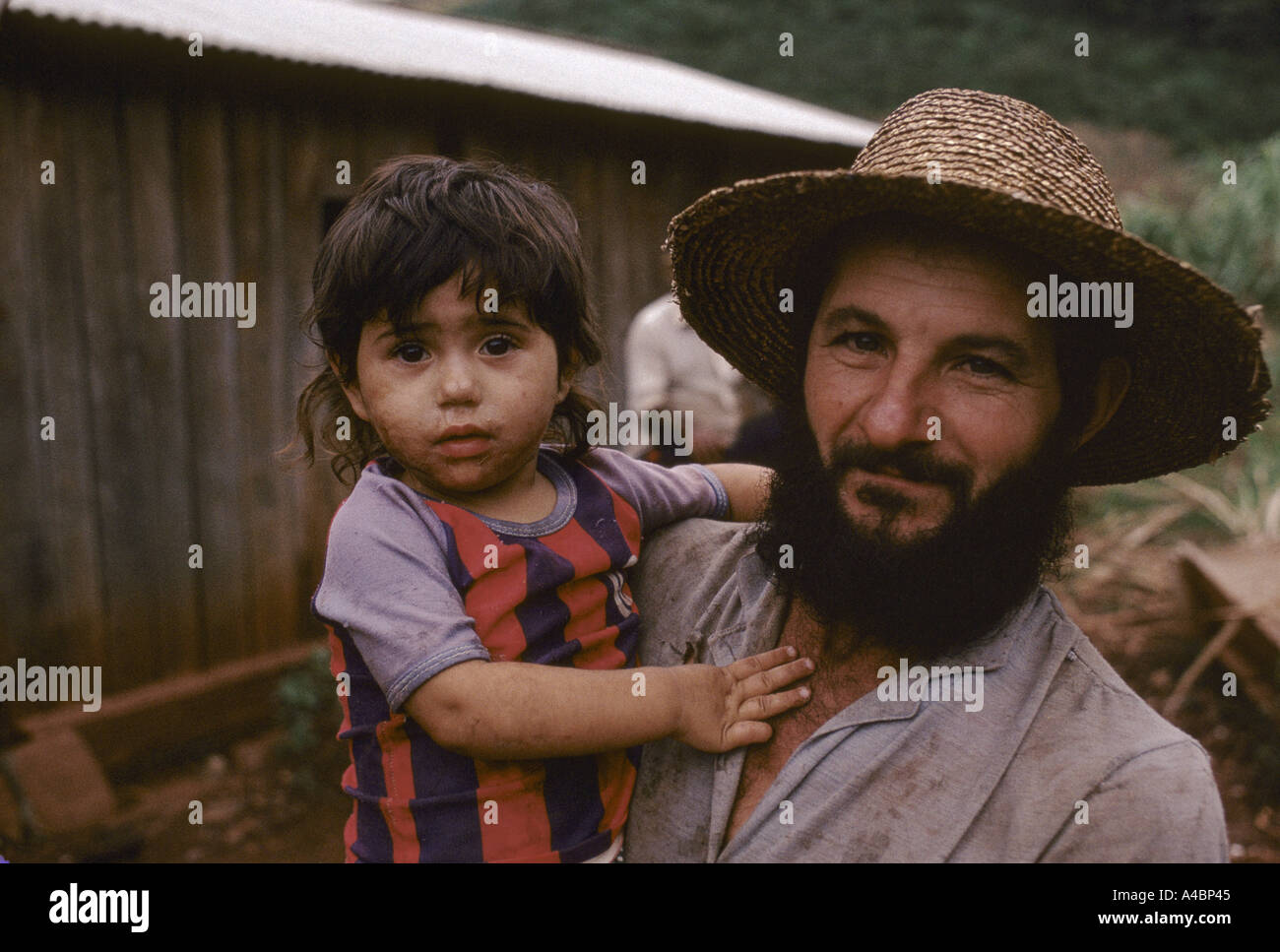 Parana Province, Brazil: A farmer holds his daughter at the succesful land invasion at Vitoria. Stock Photo