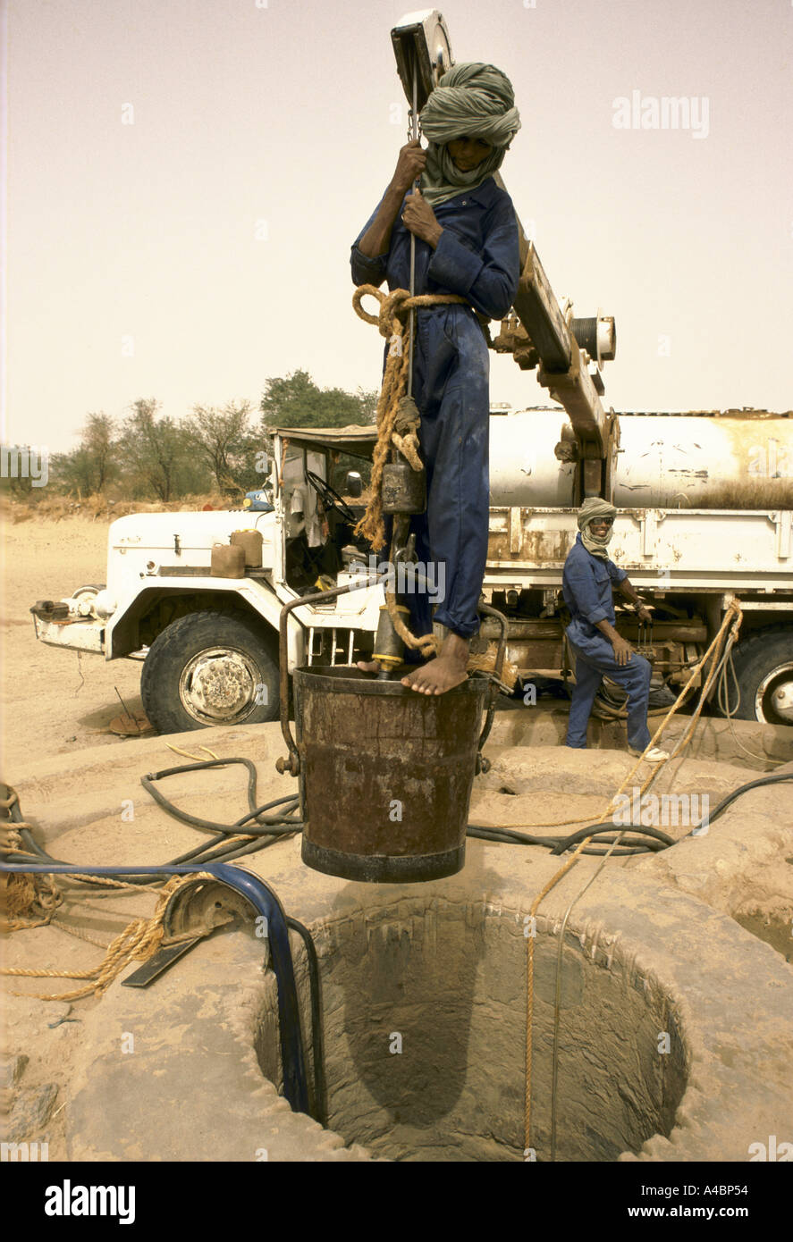 Workmen dig a new well, paid for by an NGO, lined with coriggated iron for a drought stricken Agelock village, Mali Stock Photo