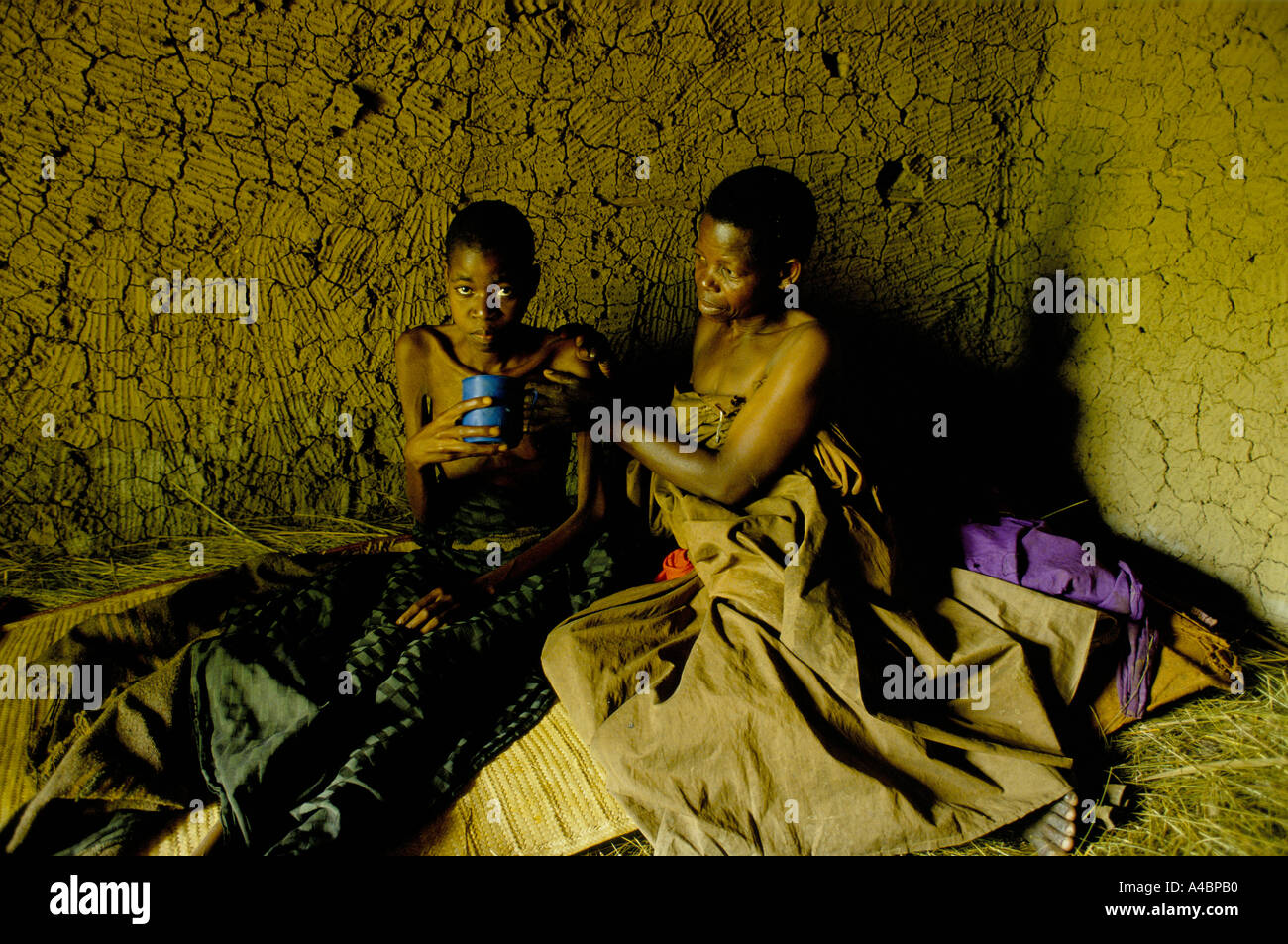 HIV AIDS victim with her mother at home. In villages in Rakai Province ...