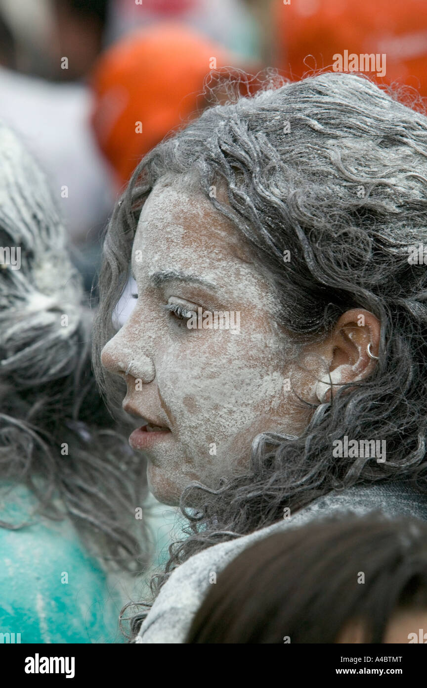 Teenage girl with face and hair covered in flour, opening ceremony