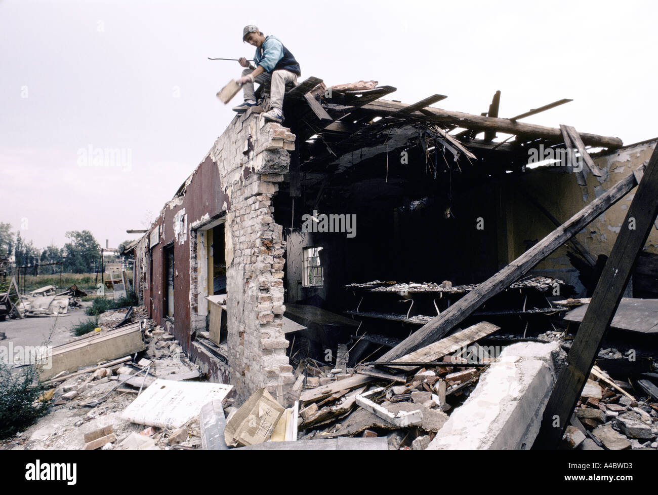 Vukovar, Croatia, under Serb control,  Feb 1992: a man laughs as he salvage what he can from the wreckage of his house Stock Photo
