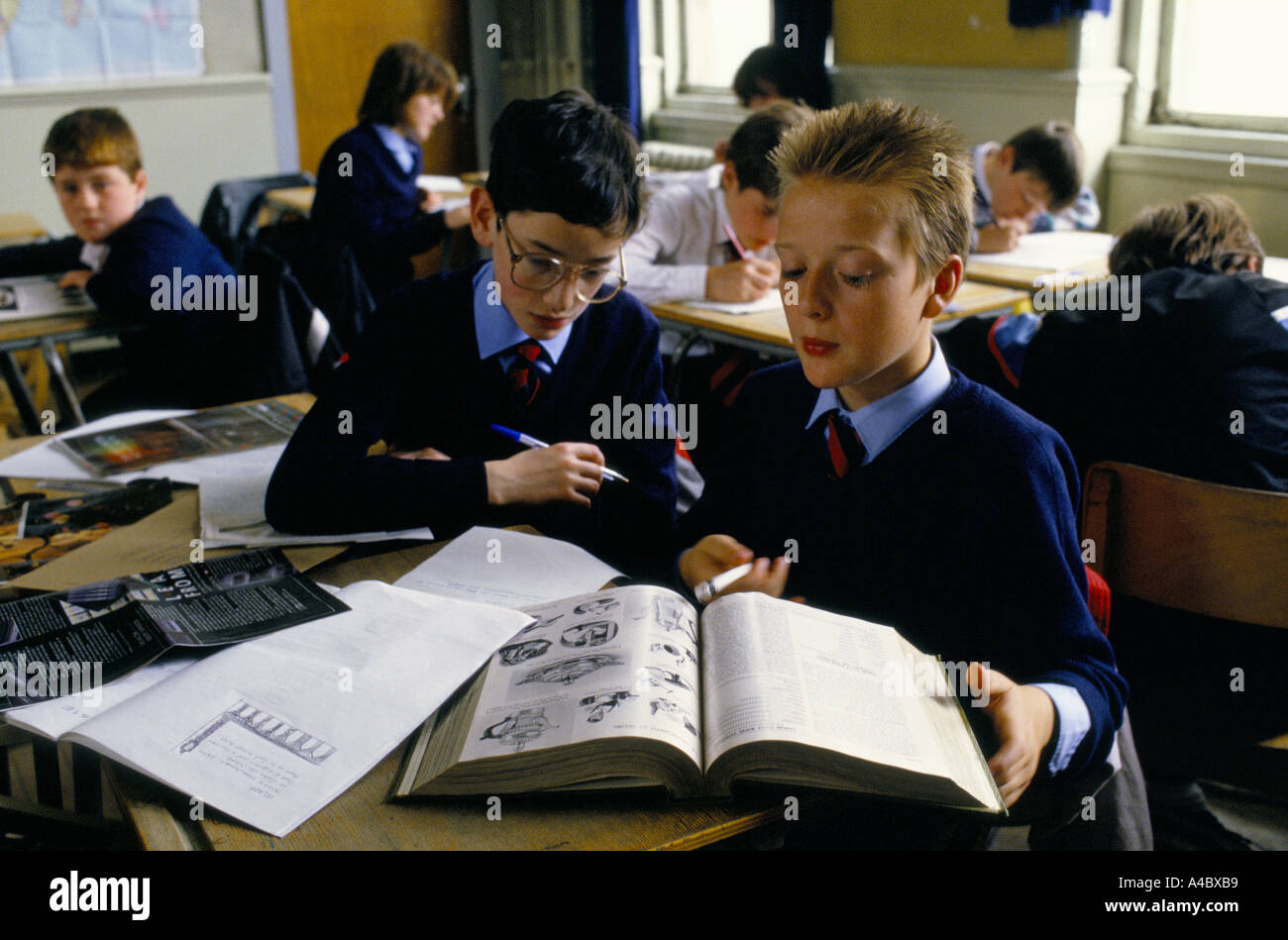 Boys work together in class on a history project at a state secondary school. Stock Photo
