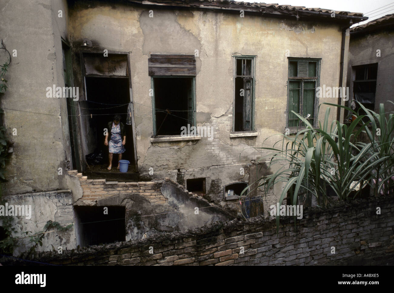 A woman in the doorway of her rented cortico housing - grand old houses divided into tiny rooms Sao Paulo Brazil Stock Photo