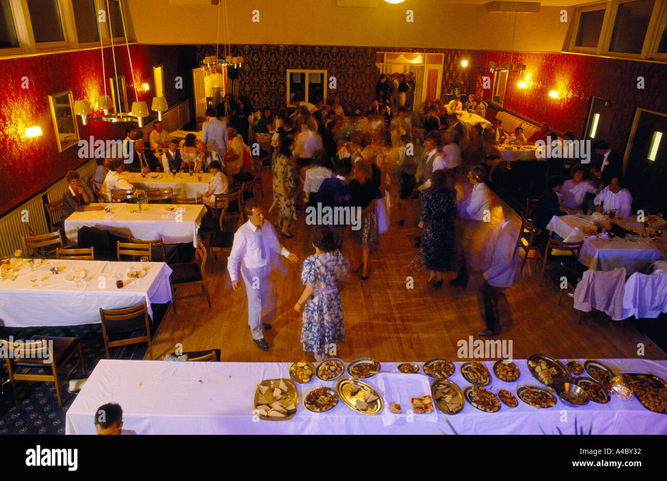 BUFFET LAYED OUT AT WEDDING RECEPTION & PEOPLE DANCING, Stock Photo