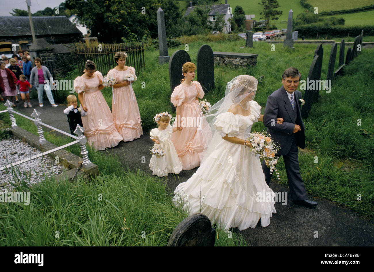 bride father bridesmaids and other spectators entering church on day of wedding Stock Photo