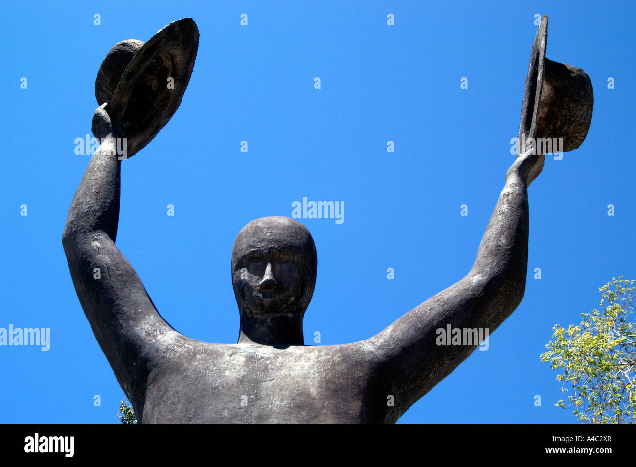 Statue of man holding two hats Stock Photo Alamy
