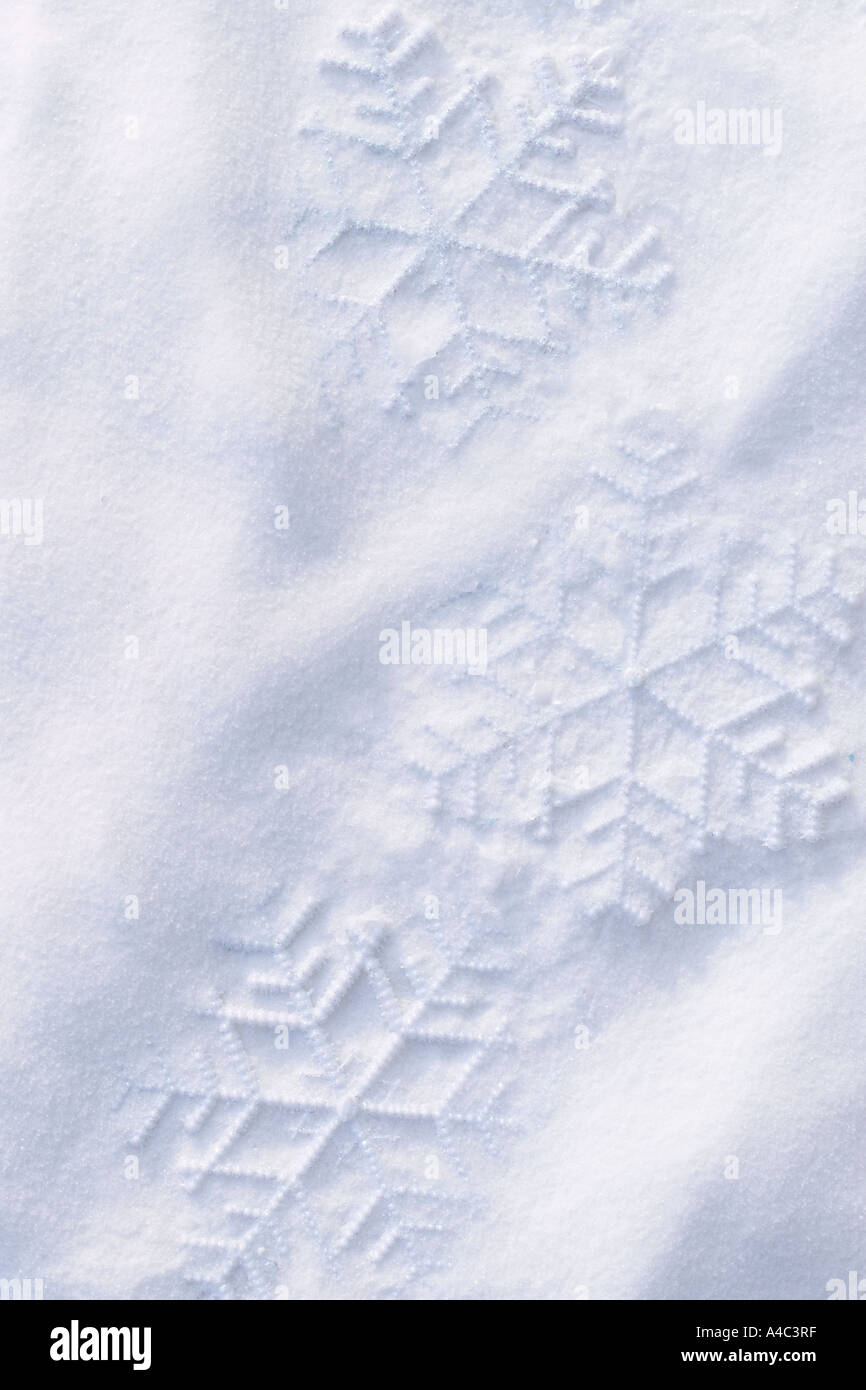 Snowflake Shapes in Snow Stock Photo - Alamy