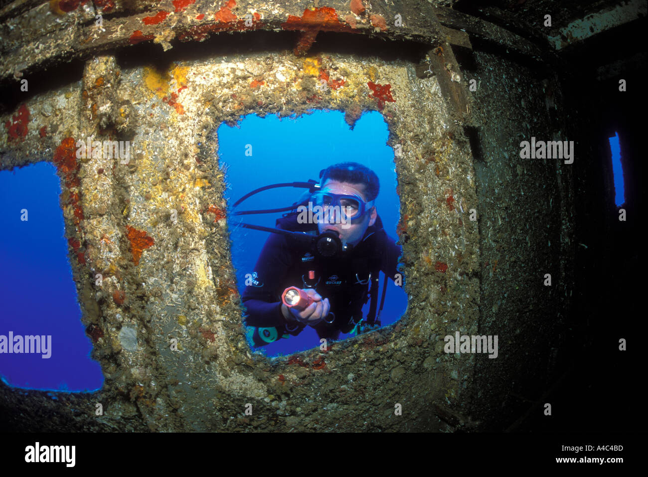 MALE SCUBA DIVER ON THE BRIDGE OF THE HICKORY WRECK IN THE DOMINICAN