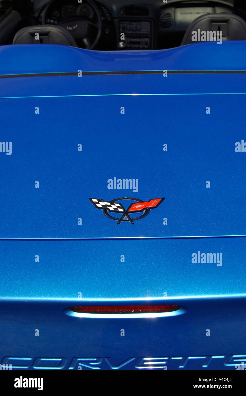 Chevrolet Corvette logo on metallic blue paint with crossed racing
