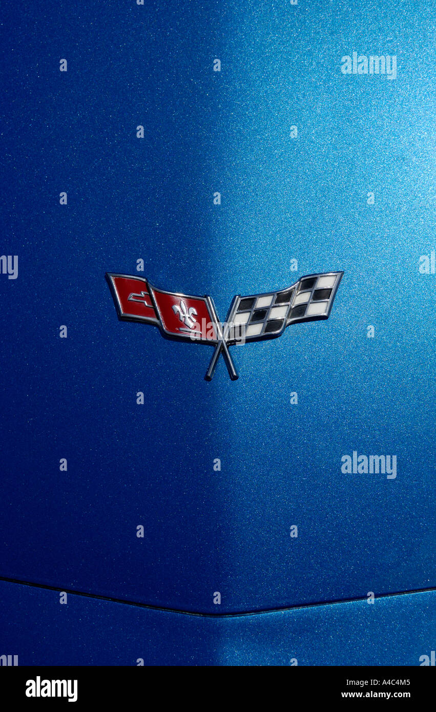 Chevrolet Corvette logo on metallic blue paint crossed racing flags