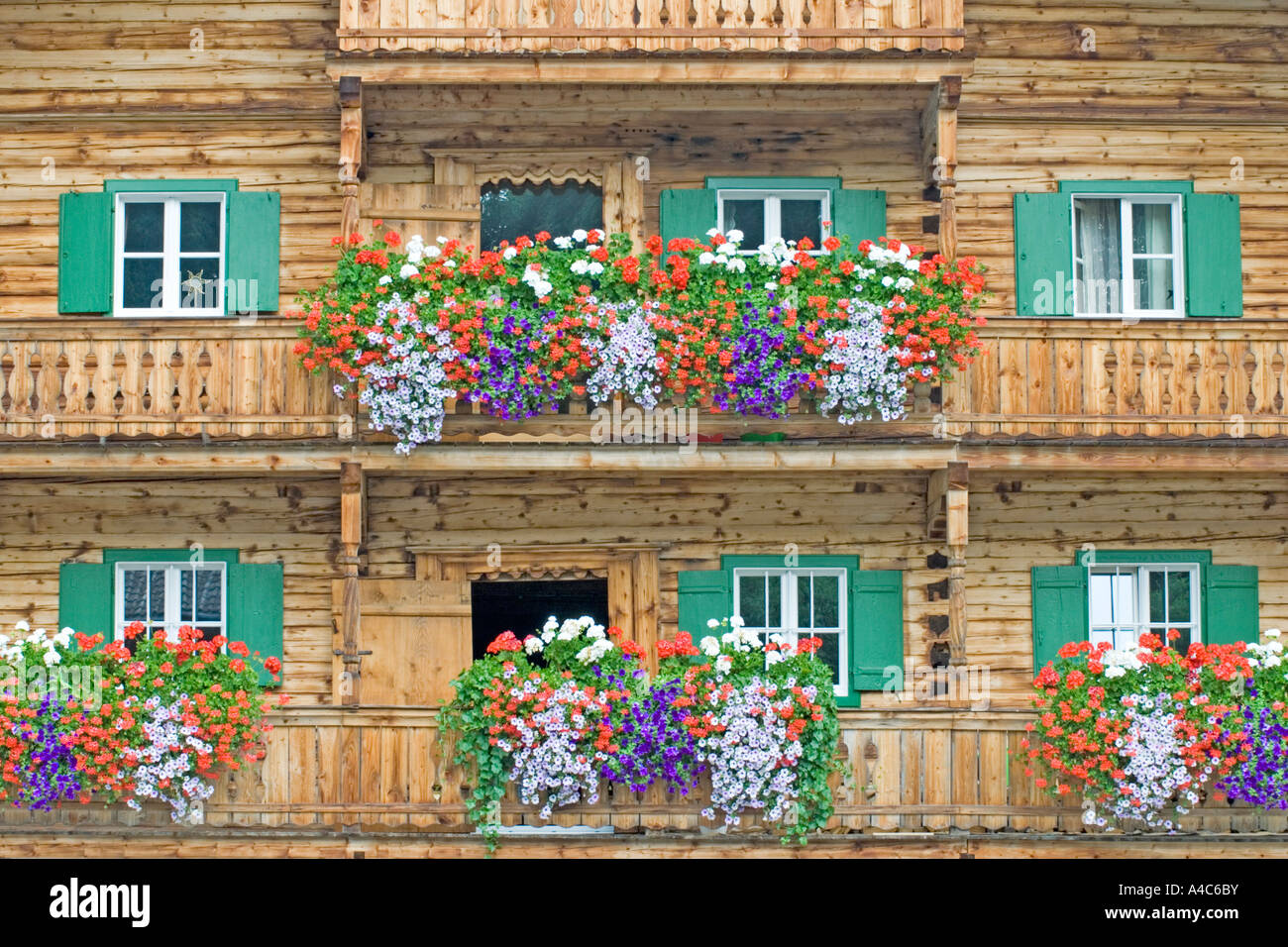 Well-filled flower boxes decorate the guesthouse Huberwirt in the village of Oberaurach near Kitzbuehl, Tyrol, Austria Stock Photo