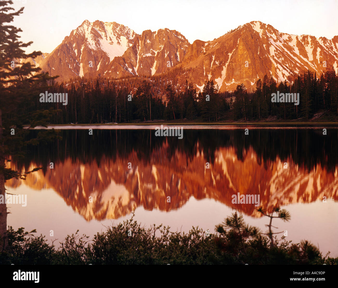 Frog Lake at sunrise with Castle Peak reflected in the still waters in