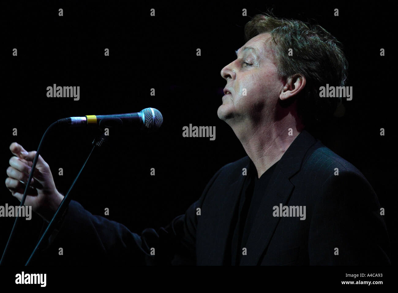 Paul McCartney sings Yesterday as a tribute to George Harrison at a Tribute concert Empire Theatre Liverpool 2002 Stock Photo