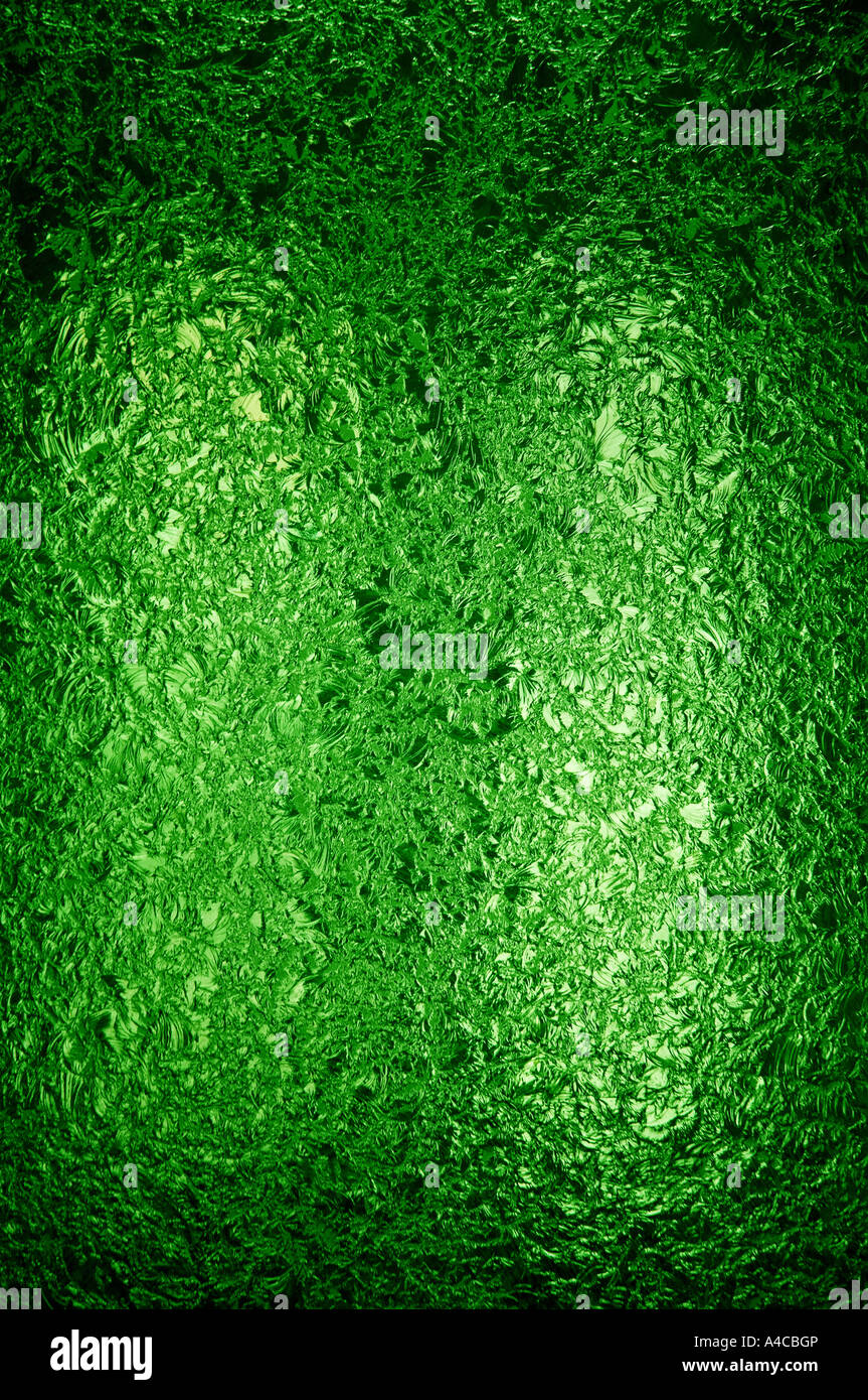 A backlit pane of beautifully textured deep green stained glass. Space