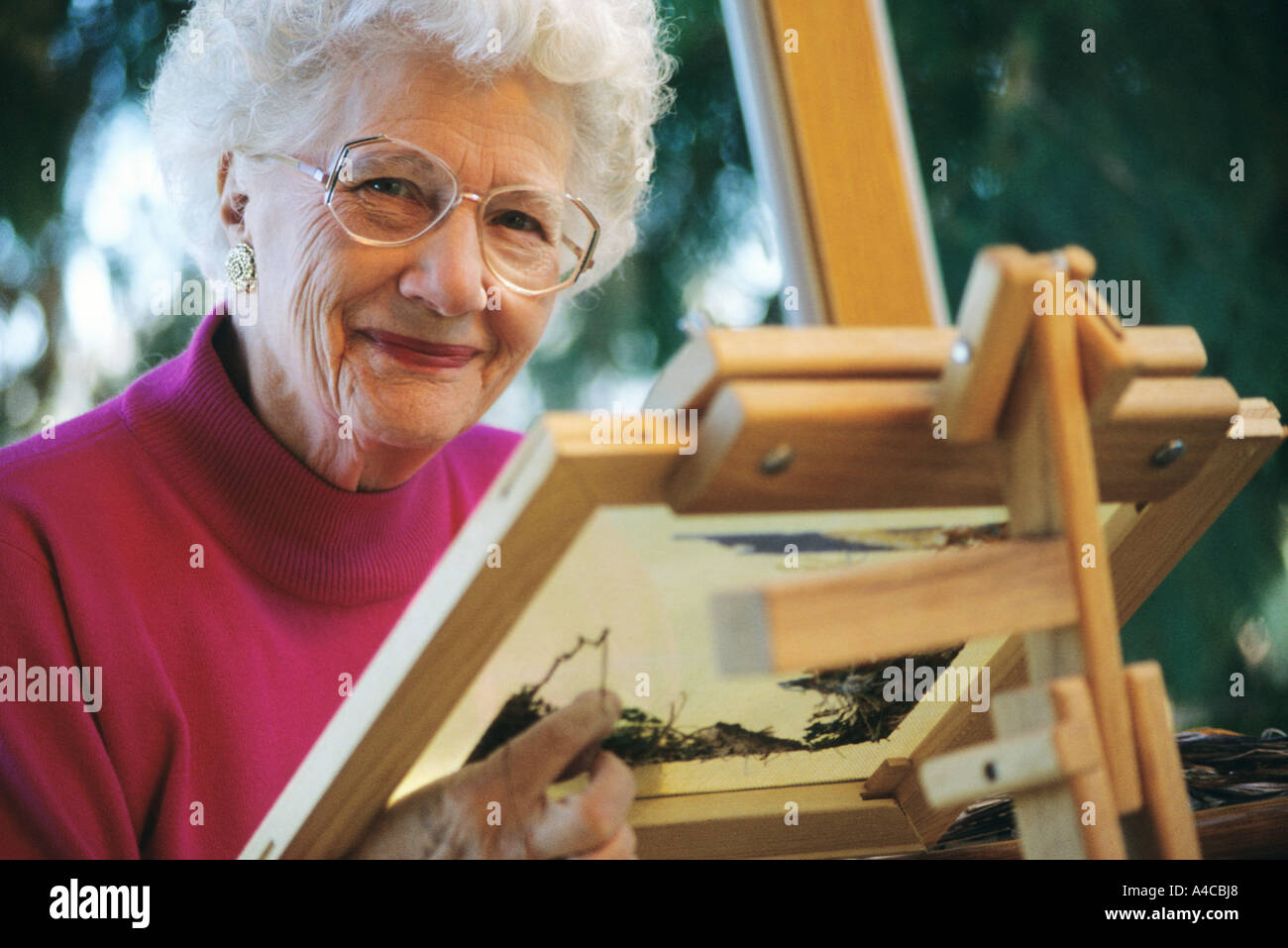 Senior woman doing needle point Stock Photo - Alamy