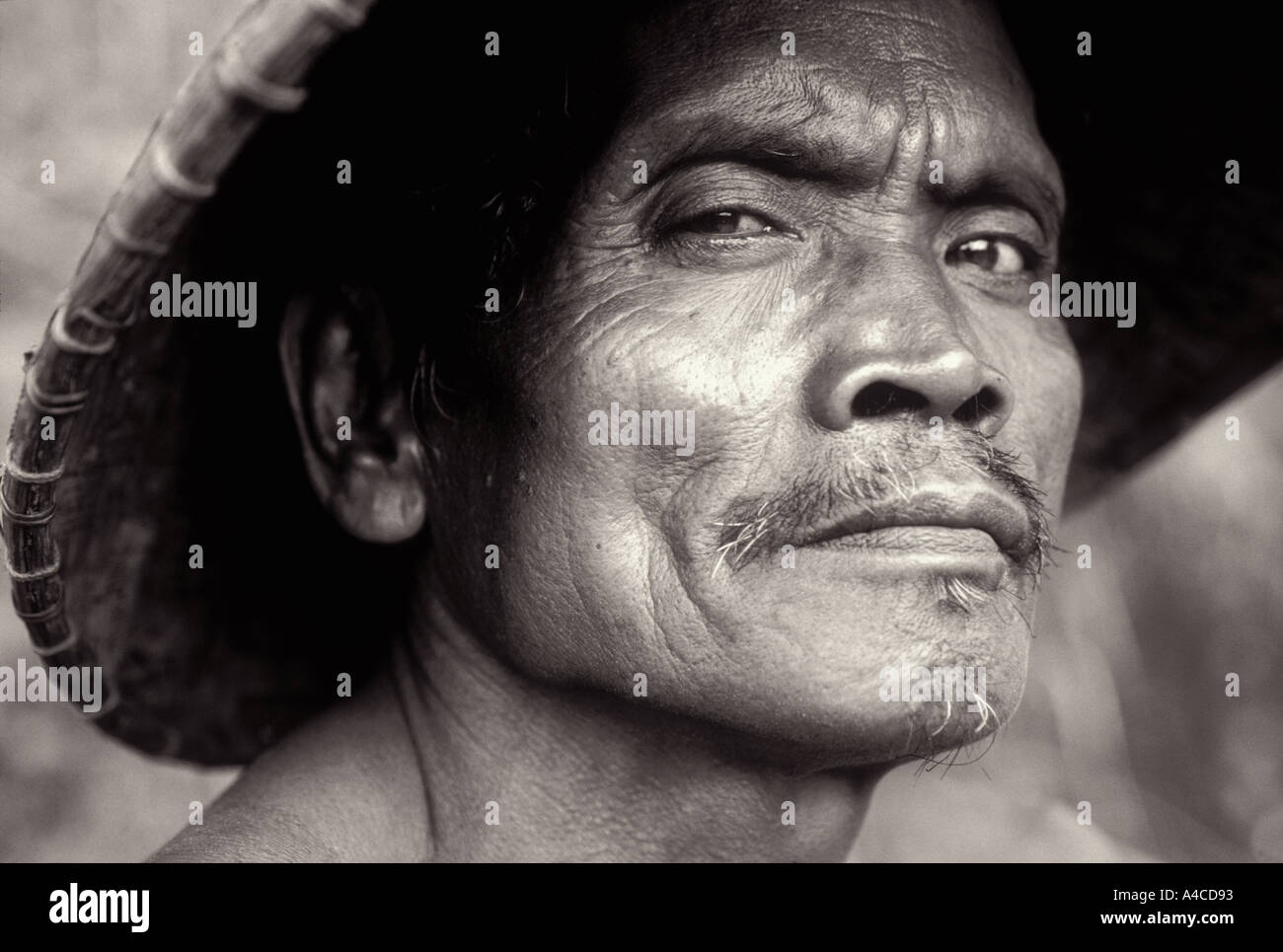 Balinese rice farmer wearing straw hat 