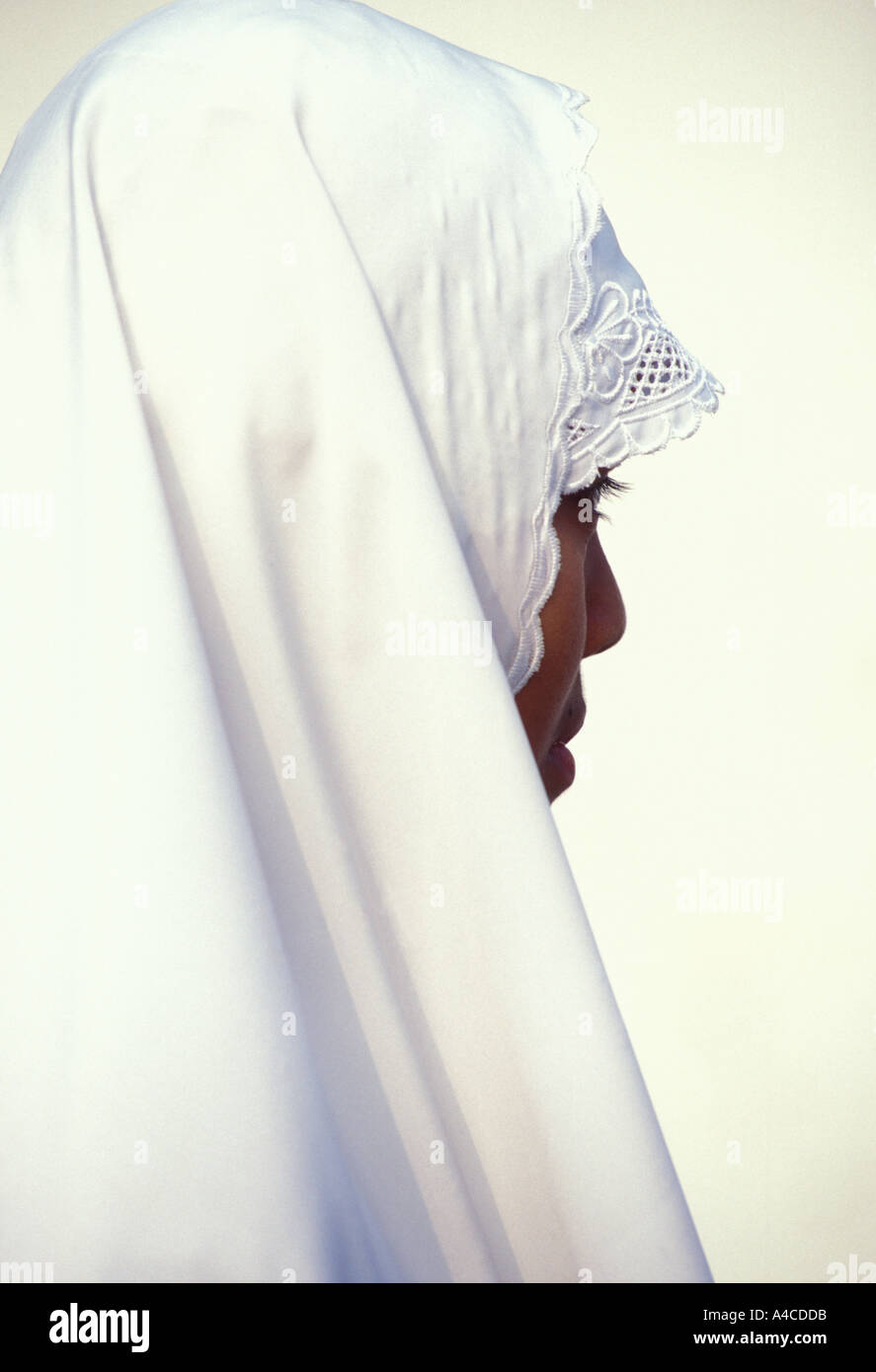 Side view of woman in traditional muslim dress Java Indonesia Southeast ...