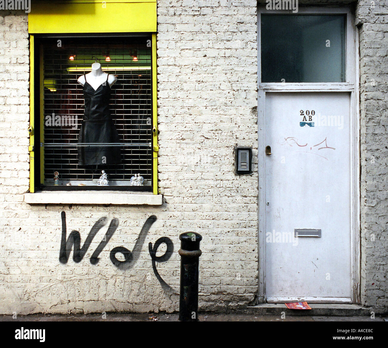 Dress shop window and front door, off Brick Lane in Londons East End Stock Photo