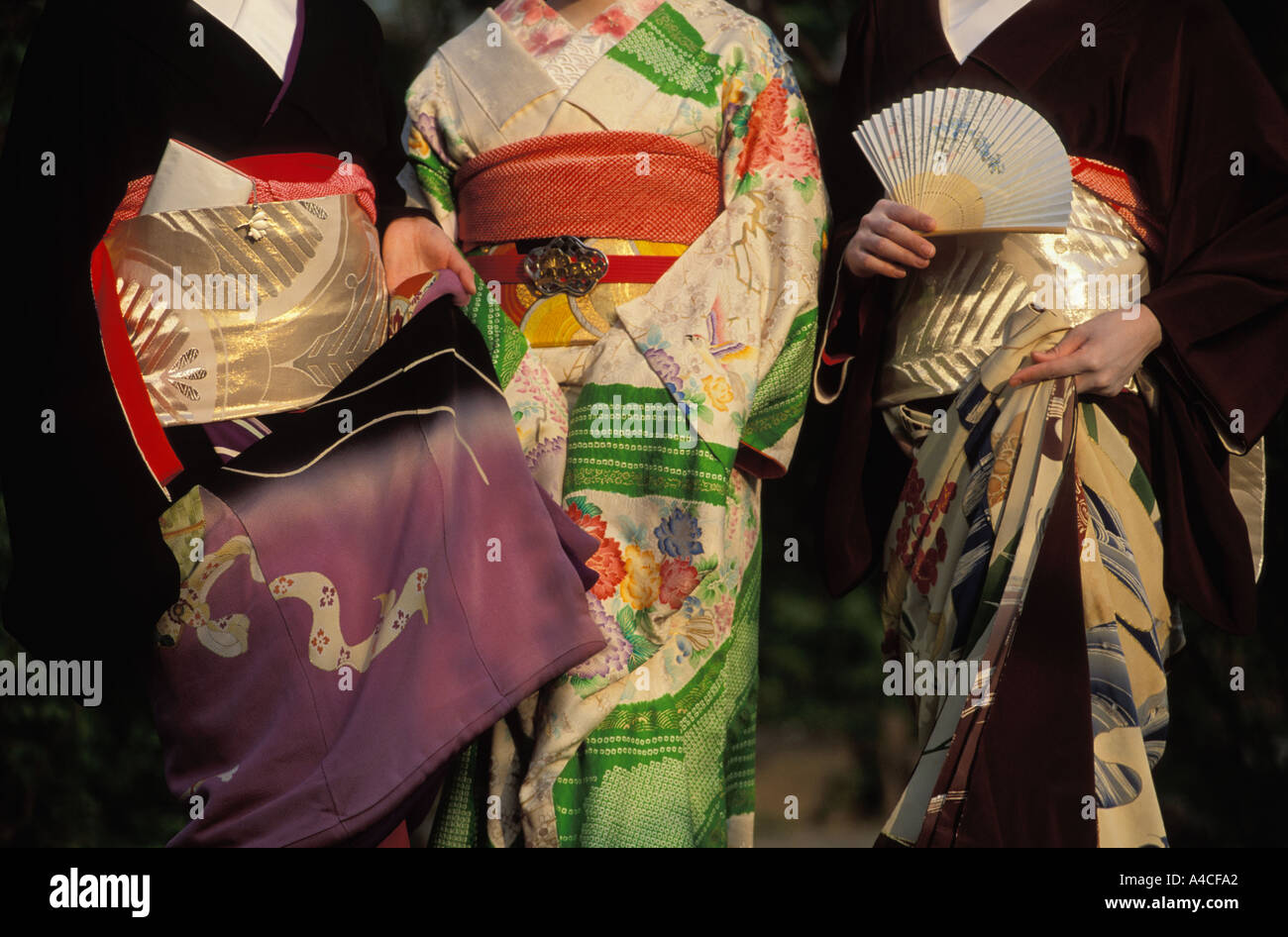 Three Japanese women wearing colorful kimonos Stock Photo