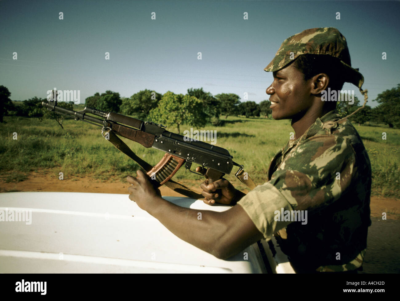 soldier wearing jungle camouflage uniform brandishing automatic weapon  mozambique frelimo civil guard convoy Stock Photo - Alamy