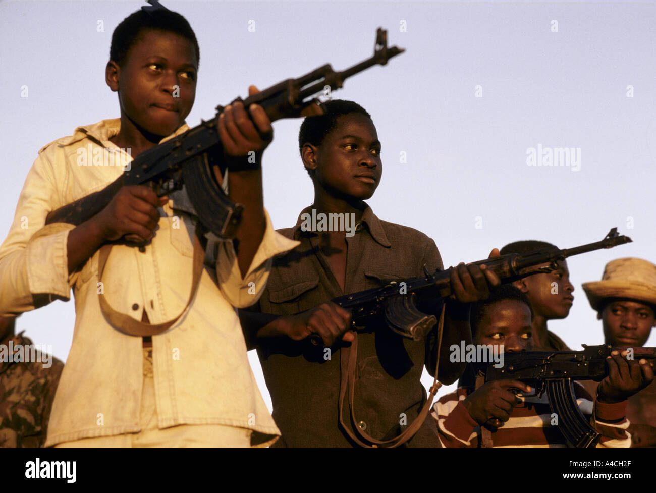 young male soldiers brandishing automamtic weapons mozambique frelimo civil  guard convoy Stock Photo - Alamy
