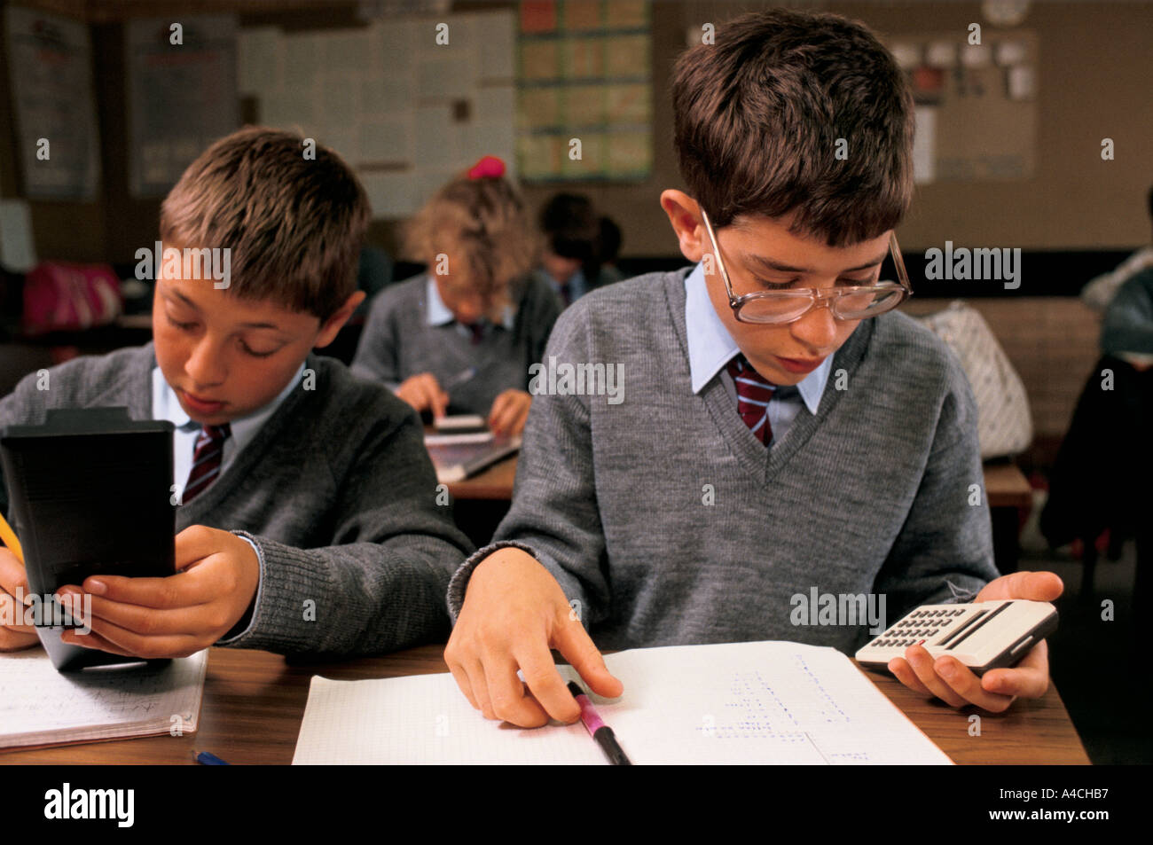 Boys and girls in a mixed comprehensive school use calculators during a