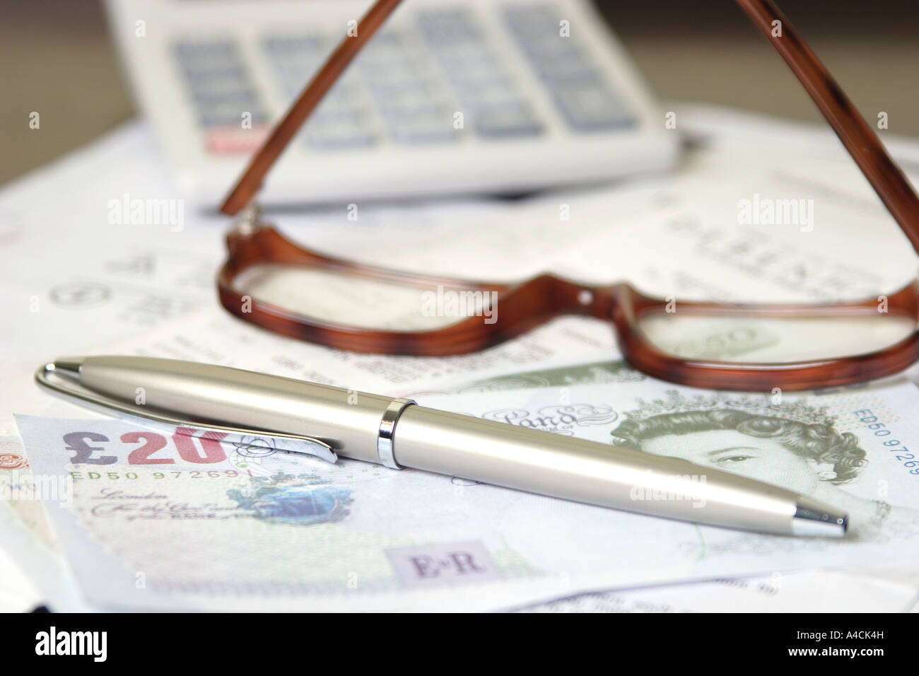 bill, calculator, cash, pen and glasses Stock Photo